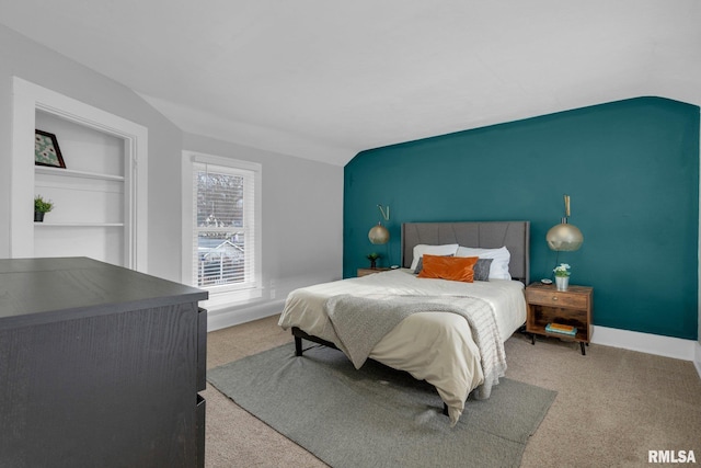 bedroom with lofted ceiling and carpet