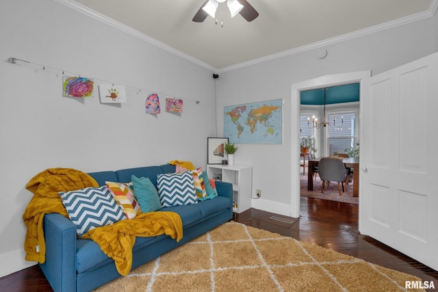 living room with dark hardwood / wood-style flooring, ceiling fan with notable chandelier, and ornamental molding