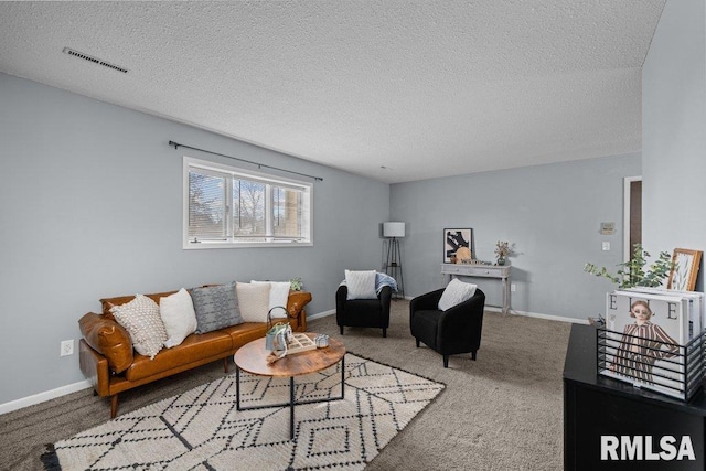 carpeted living room featuring a textured ceiling