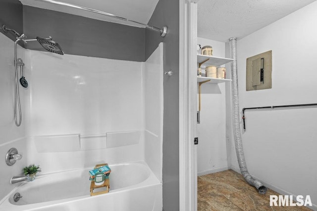 bathroom featuring shower / washtub combination, electric panel, and a textured ceiling