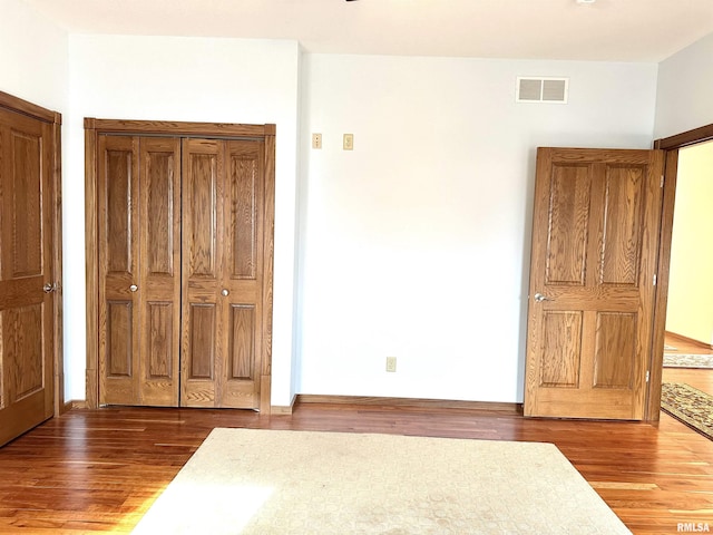 unfurnished bedroom featuring wood-type flooring