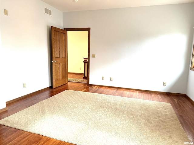 unfurnished room featuring dark hardwood / wood-style floors