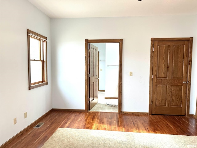 empty room with hardwood / wood-style floors