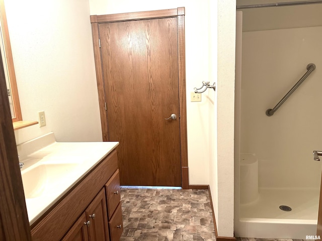 bathroom with walk in shower and vanity