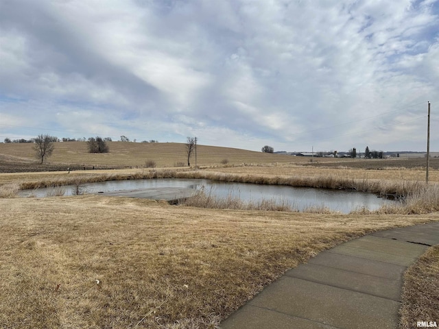 view of yard with a water view and a rural view