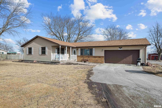 ranch-style house featuring a garage and covered porch