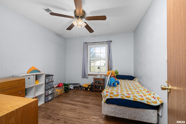 bedroom with ceiling fan and dark hardwood / wood-style floors