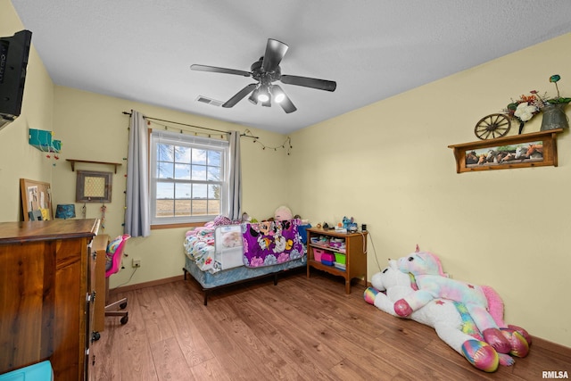 bedroom with ceiling fan and wood-type flooring