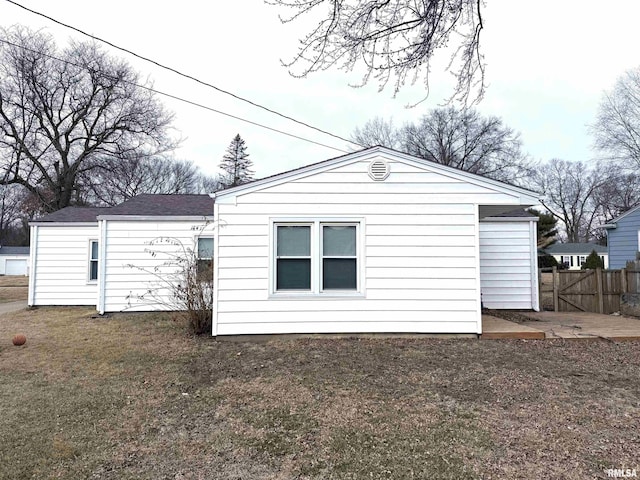 rear view of house with a yard