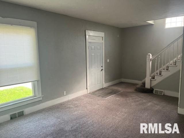 1015 Arlington Ct, Davenport, IA 52803 - carpeted foyer with visible vents, stairs, and plenty of natural light