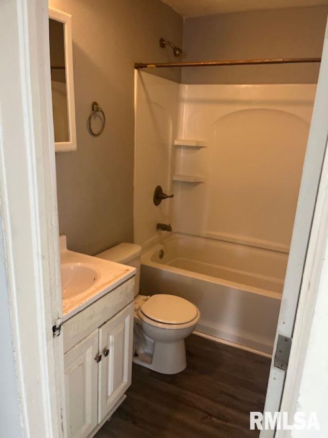 1015 Arlington Ct, Davenport, IA 52803 - bathroom with vanity, toilet, wood finished floors, and shower / bathing tub combination