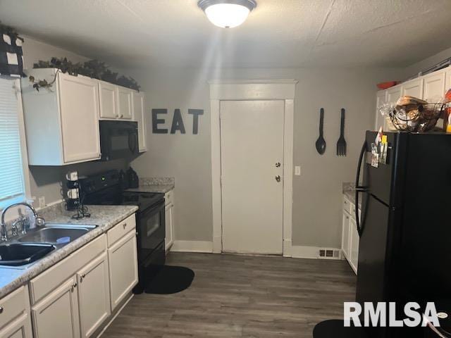 kitchen featuring sink, black appliances, a textured ceiling, dark hardwood / wood-style flooring, and white cabinets