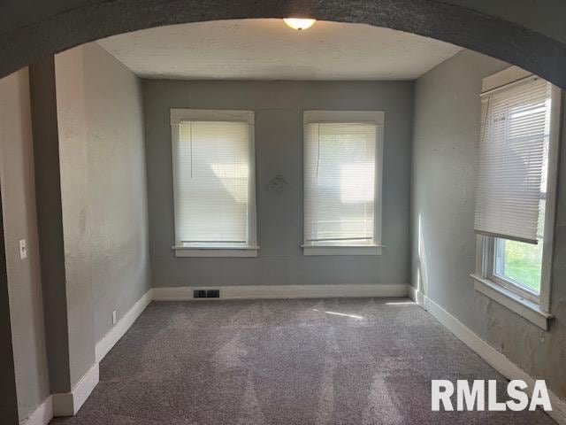 1015 Arlington Ct, Davenport, IA 52803 - carpeted spare room with visible vents, arched walkways, and baseboards