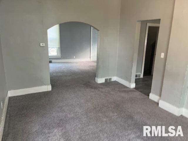 1015 Arlington Ct, Davenport, IA 52803 - carpeted empty room with arched walkways and baseboards
