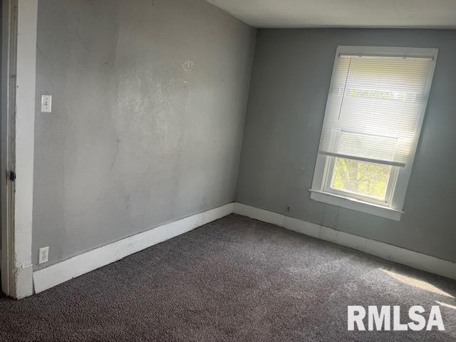 1015 Arlington Ct, Davenport, IA 52803 - spare room featuring baseboards and carpet flooring