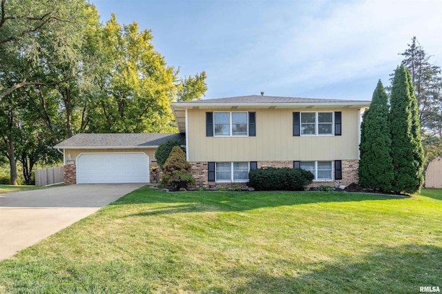 tri-level home with a garage and a front lawn