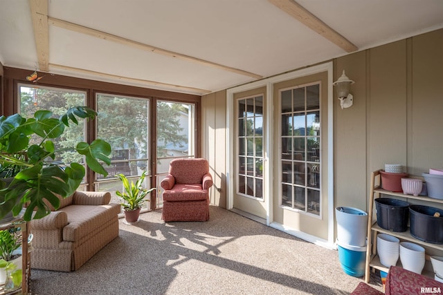 sunroom featuring beam ceiling