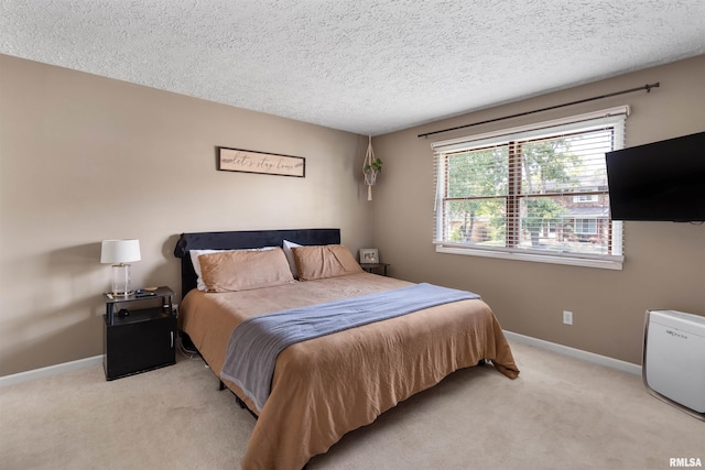 carpeted bedroom featuring a textured ceiling