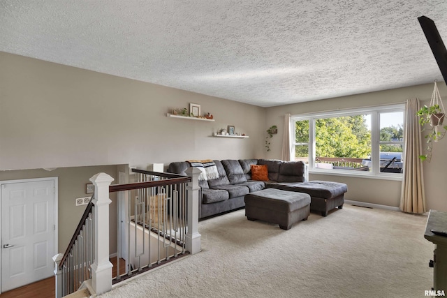 living room featuring carpet flooring and a textured ceiling