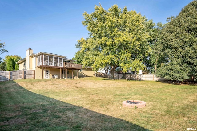 view of yard with a fire pit and a sunroom