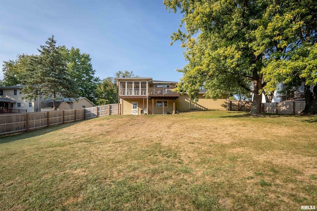 view of yard featuring a wooden deck and a sunroom