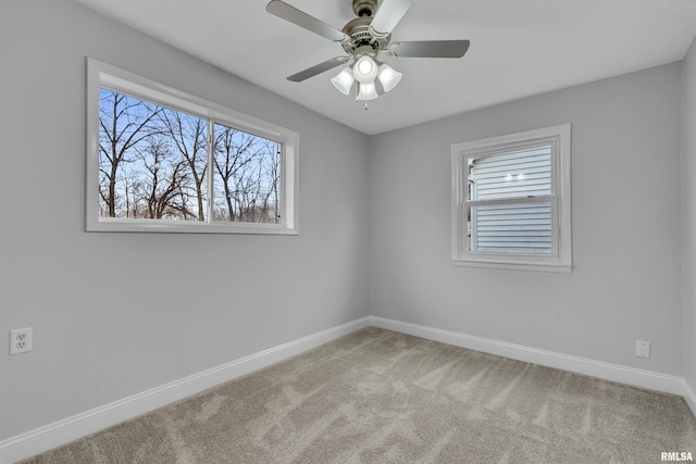 empty room featuring ceiling fan and carpet floors