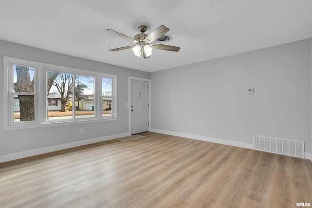 empty room featuring ceiling fan and light wood-type flooring