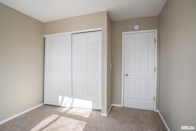 unfurnished bedroom featuring a closet and carpet