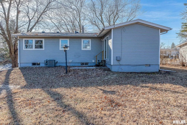 rear view of house featuring central AC unit