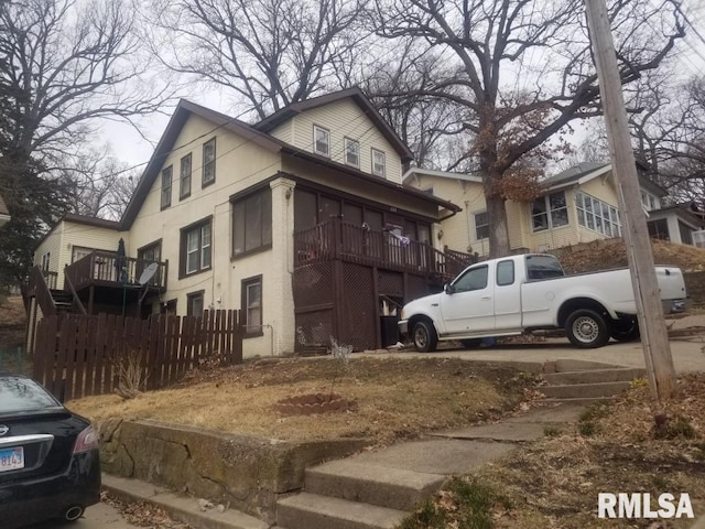 view of side of home featuring fence