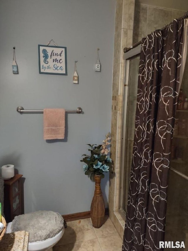 bathroom with tile patterned flooring, a shower with curtain, and toilet