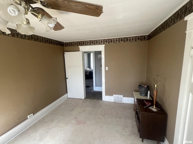 unfurnished bedroom with baseboards, carpet, and visible vents