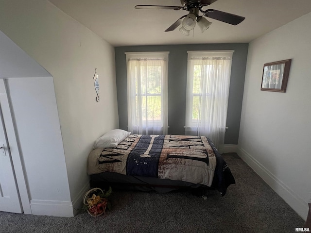 carpeted bedroom with baseboards and ceiling fan