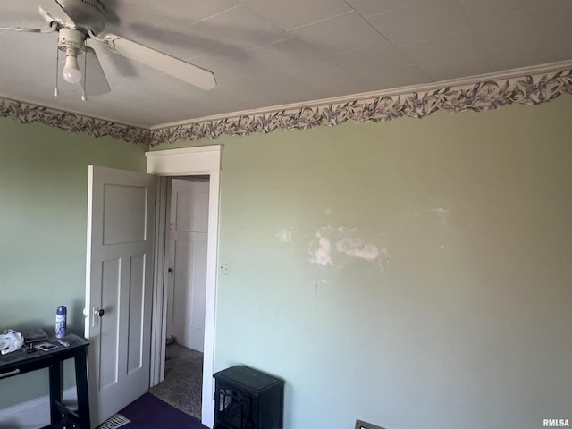 unfurnished bedroom featuring ceiling fan and ornamental molding