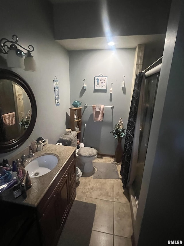 bathroom featuring tile patterned floors, vanity, toilet, and curtained shower
