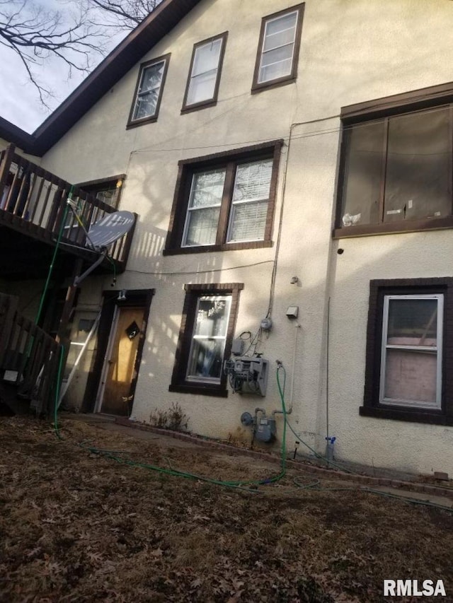 back of house with stucco siding