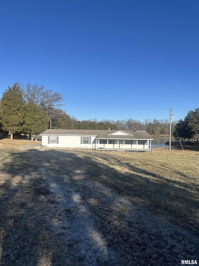 view of front of house featuring a water view and a front lawn