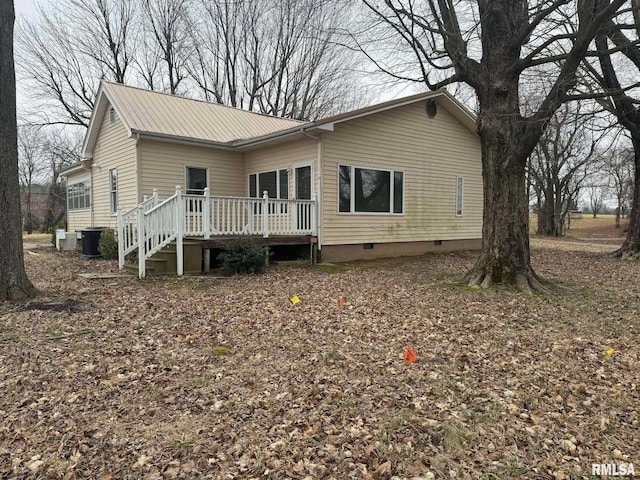 back of property featuring a wooden deck