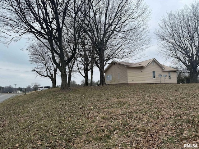 view of home's exterior with a lawn