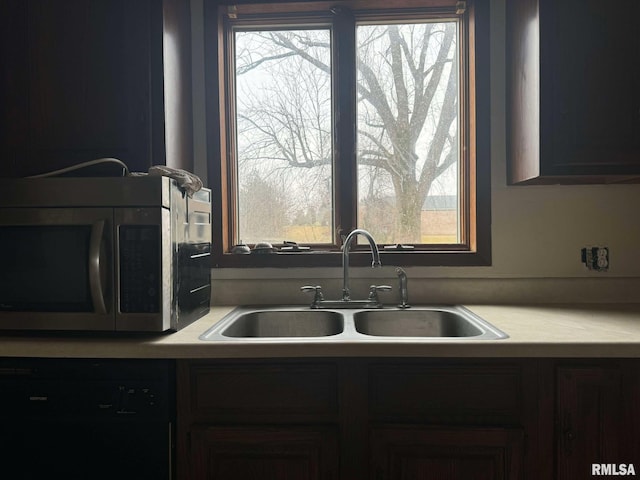 kitchen featuring sink and black dishwasher