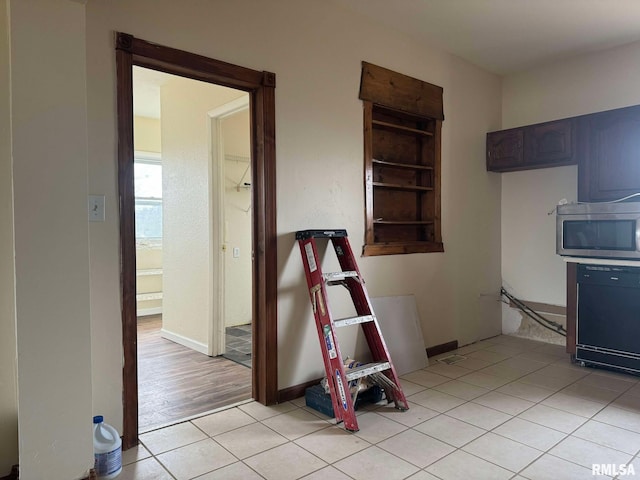 kitchen featuring black dishwasher and light tile patterned flooring