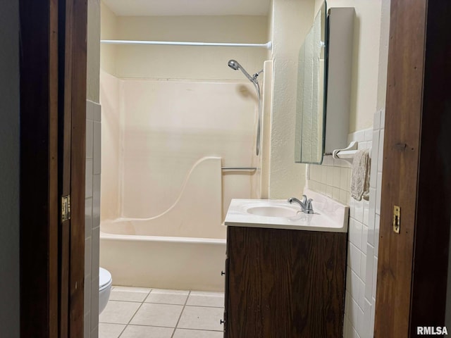 full bathroom with tile walls, vanity, shower / bathing tub combination, tile patterned floors, and toilet