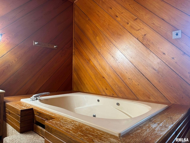 bathroom with tiled tub and vanity