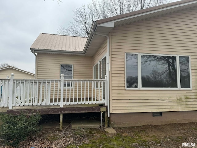 view of side of home with a wooden deck