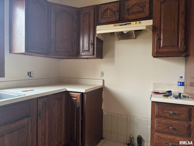 kitchen featuring dark brown cabinetry