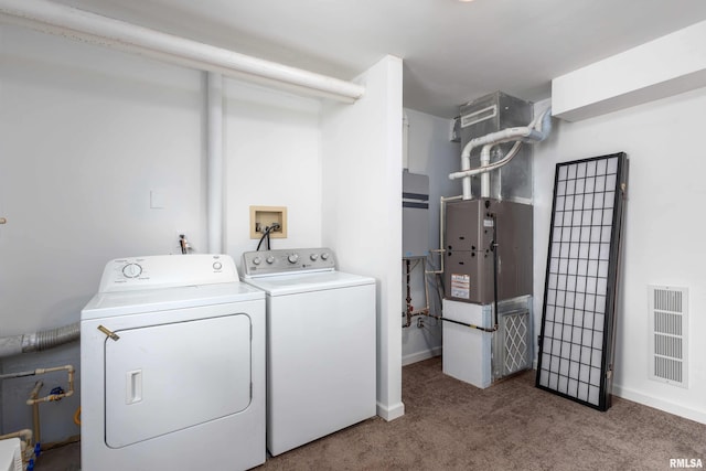 laundry room featuring baseboards, carpet floors, visible vents, independent washer and dryer, and laundry area