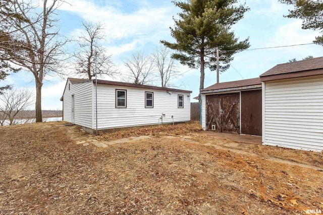 back of property with an outdoor structure