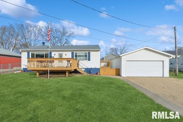 exterior space featuring a detached garage, an outdoor structure, a lawn, and a deck