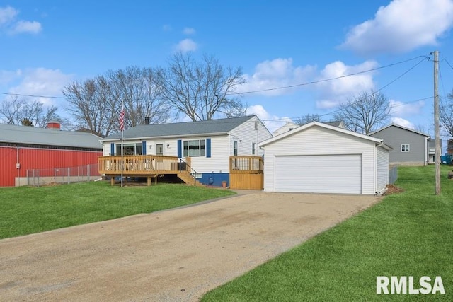 view of front of property featuring a garage, a front yard, an outbuilding, and a wooden deck