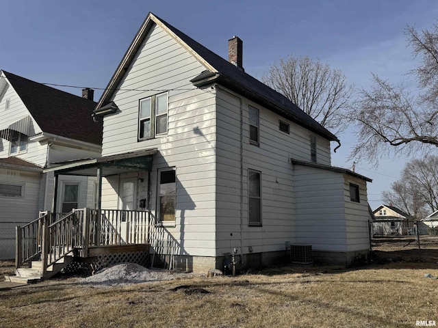 back of house with central air condition unit